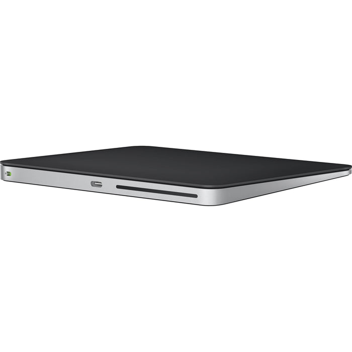 Apple Magic Trackpad in Black with a smooth glass finish and USB-C charging port