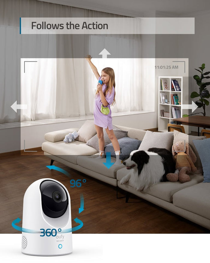 Smart home security camera in a living room with a child and dog, labeled 'Follows the Action'.