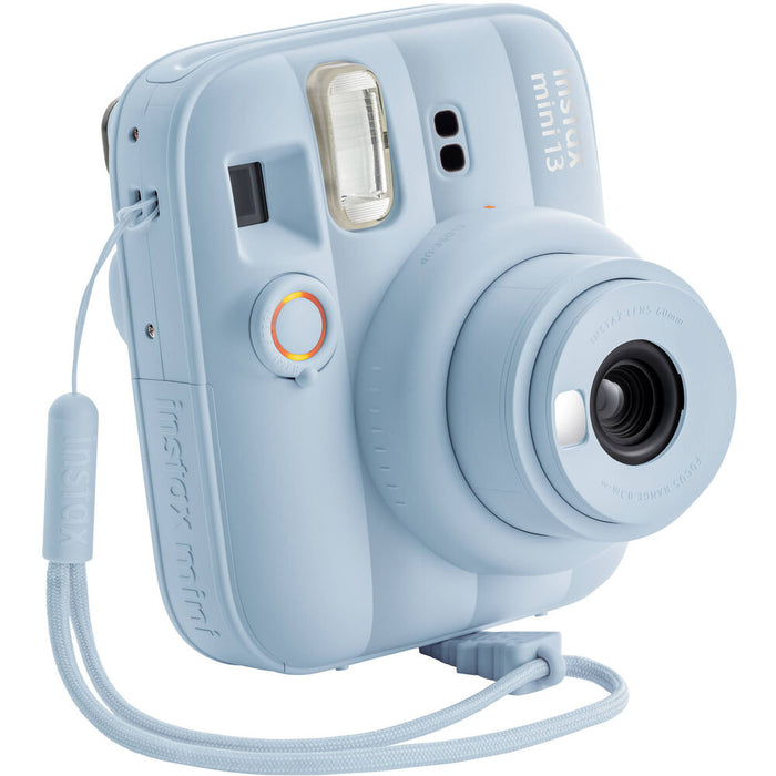 Frost Blue Instax Mini 13 with lens extended, showing wrist strap