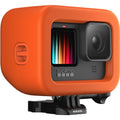 GoPro camera with an orange protective case on a white background