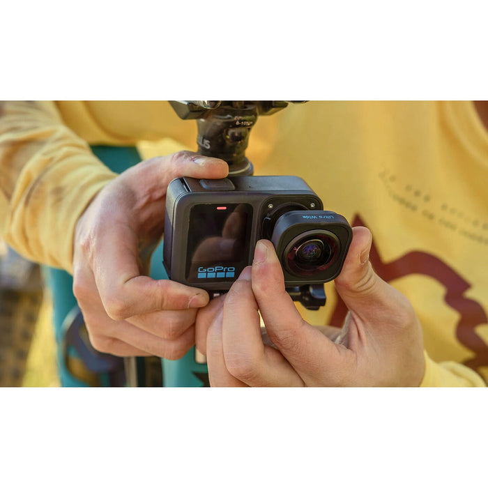 Person holding a GoPro camera with a blurred background