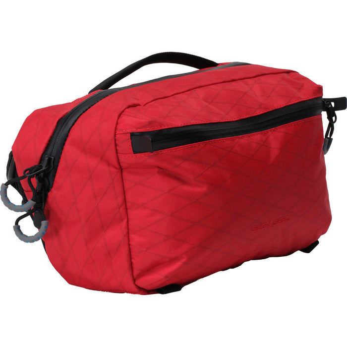 Red toiletry bag with black zippers on a white background