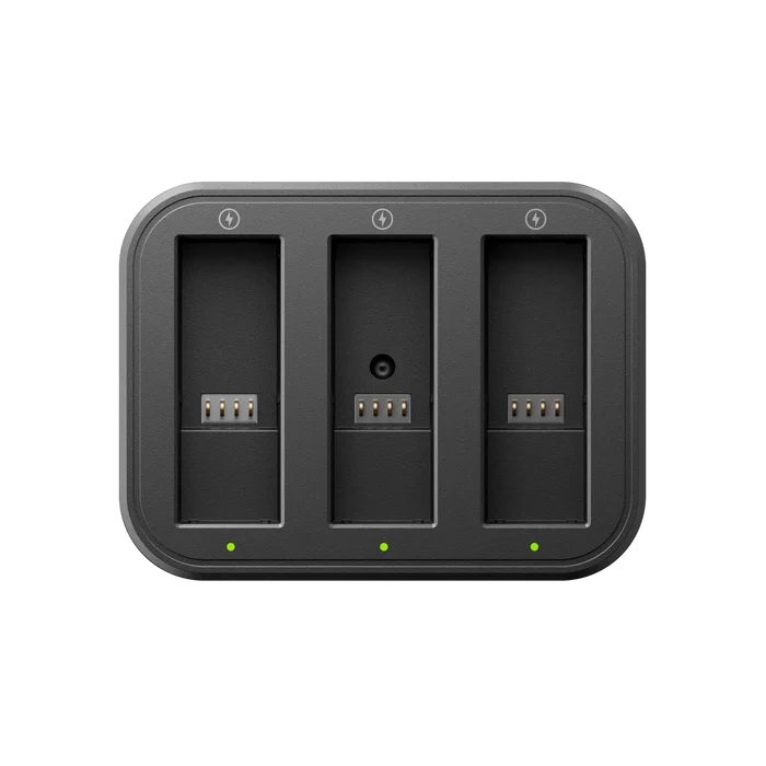 Black triple battery charger with three slots on a white background