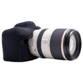 Camera lens with a black lens cap on a white background