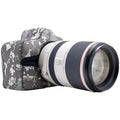 Camera with a lens and camouflage case on a white background
