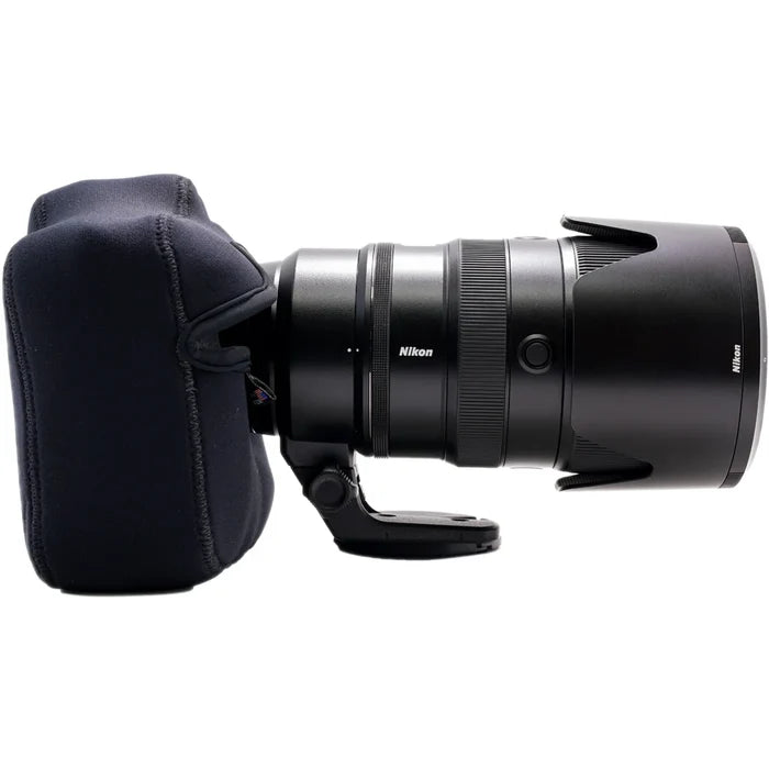 Nikon camera lens with a black protective cap on a white background