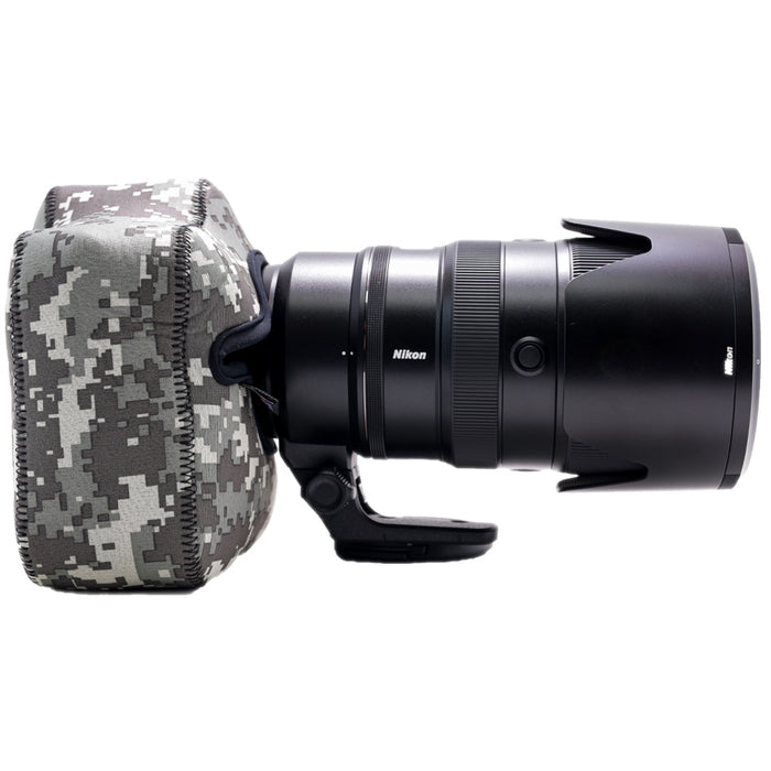 Nikon camera lens with camouflage lens hood on a white background