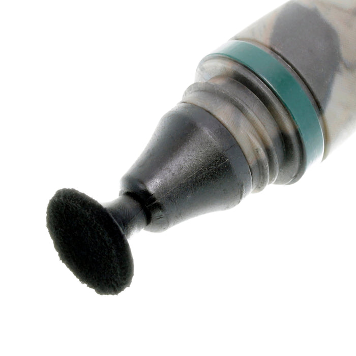 Close-up of a dental tool with a black brush head on a white background