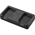Olympus BCX-1 battery charger for BLX-1 rechargeable batteries, charges two batteries simultaneously in 150 minutes, USB-C powered with power delivery compatibility.