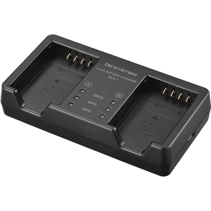 Olympus BCX-1 battery charger for BLX-1 rechargeable batteries, charges two batteries simultaneously in 150 minutes, USB-C powered with power delivery compatibility.