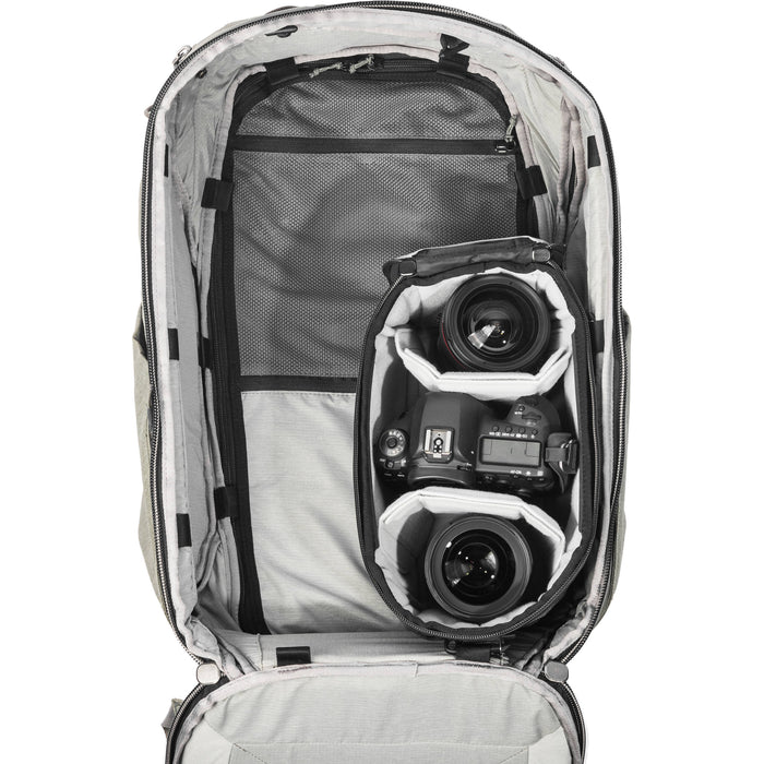 Black handheld Peak Design Camera Cube V2 with adjustable dividers, zipper closure, and durable nylon exterior, perfect for carrying camera gear safely.