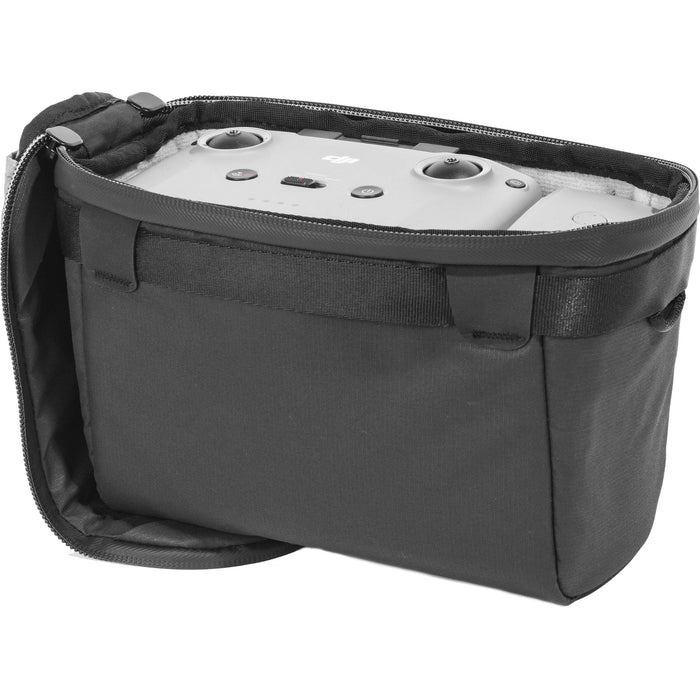 Black handheld Peak Design Camera Cube V2 with adjustable dividers, zipper closure, and durable nylon exterior, perfect for carrying camera gear safely.