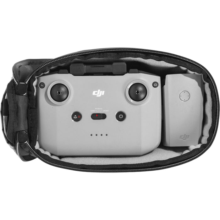 Black handheld Peak Design Camera Cube V2 with adjustable dividers, zipper closure, and durable nylon exterior, perfect for carrying camera gear safely.