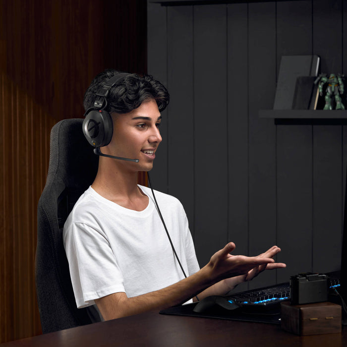 Black over-ear professional headset with adjustable boom microphone, detachable straight cable, and closed-back design.
