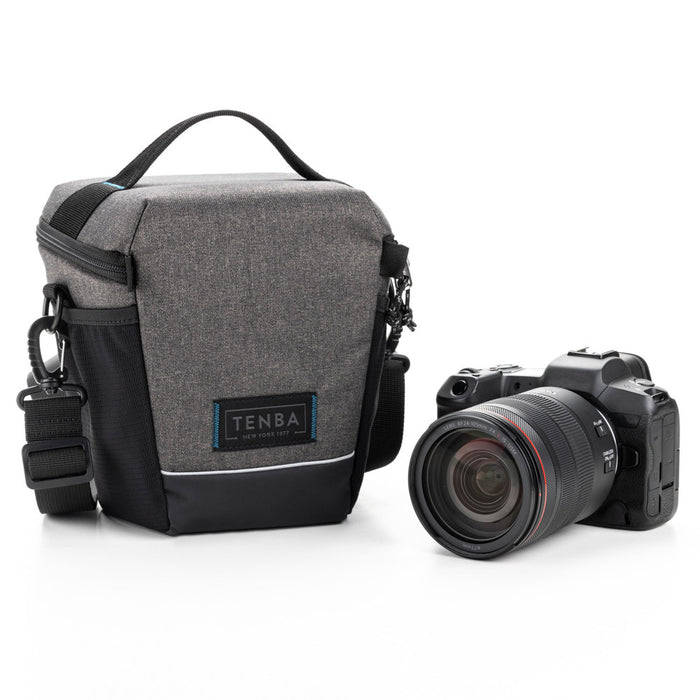 Gray camera bag with black accents and a camera on a white background
