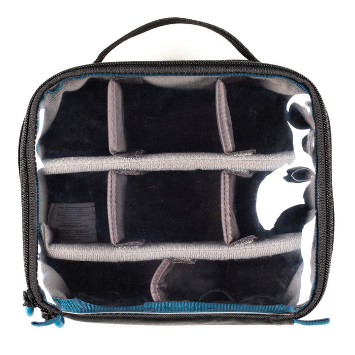 Clear travel bag with black interior compartments on a white background