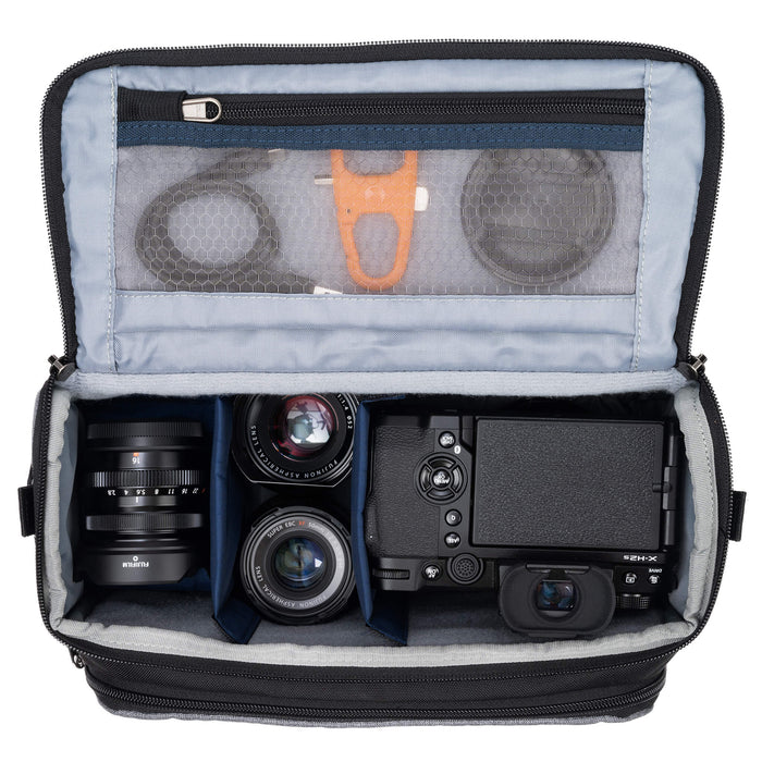 Think Tank Photo Mirrorless Mover 25 camera shoulder bag, black, compact with flip-top lid, multiple pockets, padded interior for mirrorless camera and lenses, rain cover included