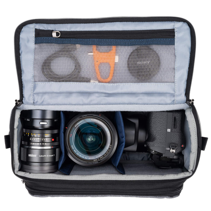 Think Tank Photo Mirrorless Mover 25 camera shoulder bag, black, compact with flip-top lid, multiple pockets, padded interior for mirrorless camera and lenses, rain cover included