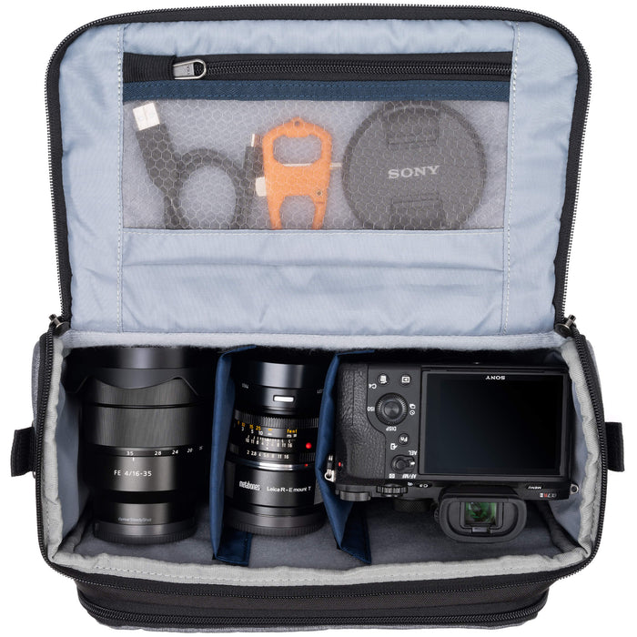Think Tank Photo Mirrorless Mover 30 camera shoulder bag, flip-top lid with magnetic closure, multiple pockets, padded interior with adjustable dividers for mirrorless camera and lenses, rain cover included