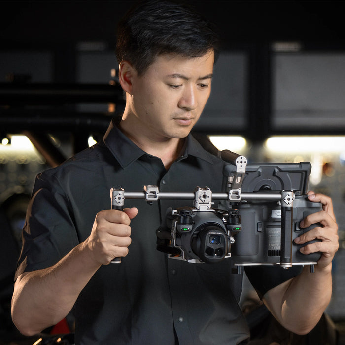 Modular camera cage with accessory mounts and audio integration for DJI Mavic 4 Pro.